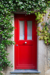 Fototapeta na wymiar Red Entrance Door with jasmine flowers