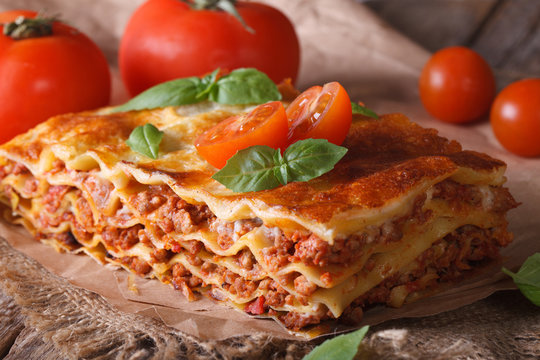 Italian lasagna close-up on the table. horizontal rustic