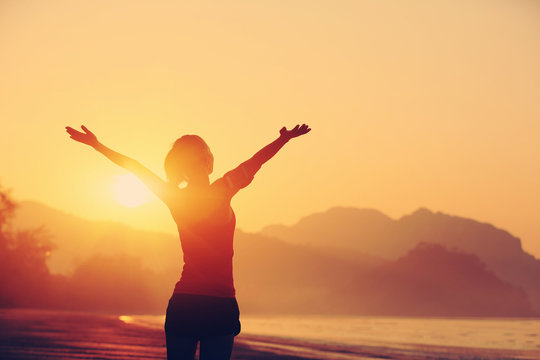 Cheering Woman Hiker Open Arms At Sunrise Seaside Beach 