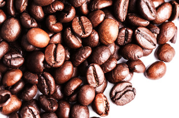 Roasted coffee beans isolated on a white background. Closeup, ma