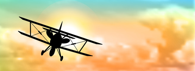 silhouette of biplane with clouds © Anikakodydkova