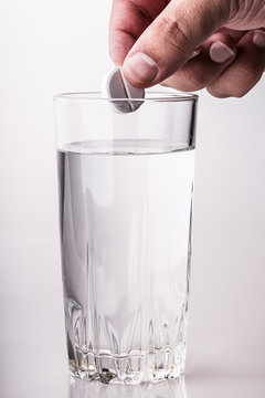 pill glass of water hand