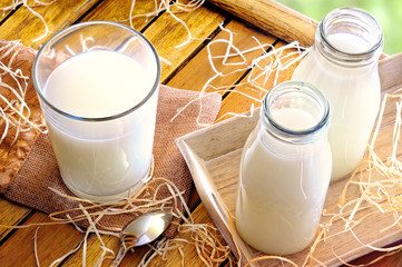 Glass of milk on a table on the field top view