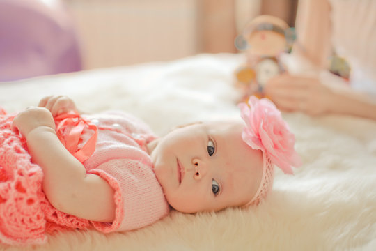 Little baby girl wearing pink knitting dress