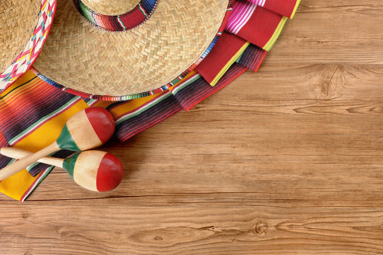 Mexican background sombreros with maracas and traditional serape blankets on natural wood floor Mexico cinco de mayo fiesta