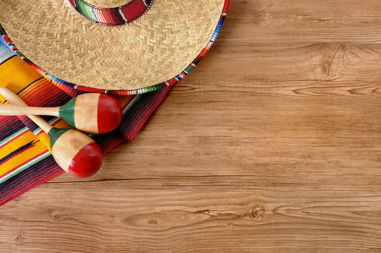 Mexican sombrero and blanket on pine wood floor