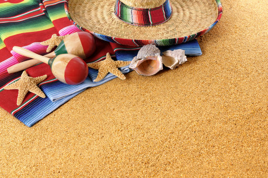 Mexican beach sand background with sombrero serape rug or blanket photo horizontal