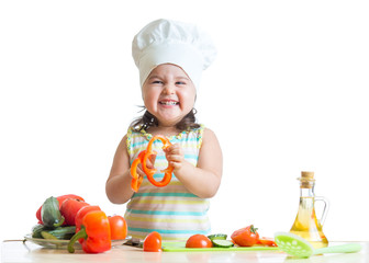 kid girl preparing healthy food in the kitchen