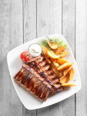 Grilled Meat, Fried Potatoes with Sauce on Plate