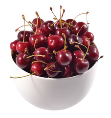 Red cherries in a white bowl on a white