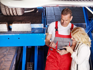 Customer and mechanic looking at a quotation