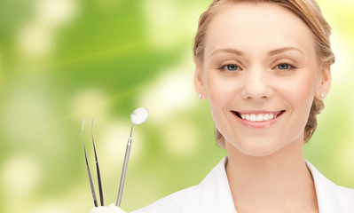 happy young female dentist with tools