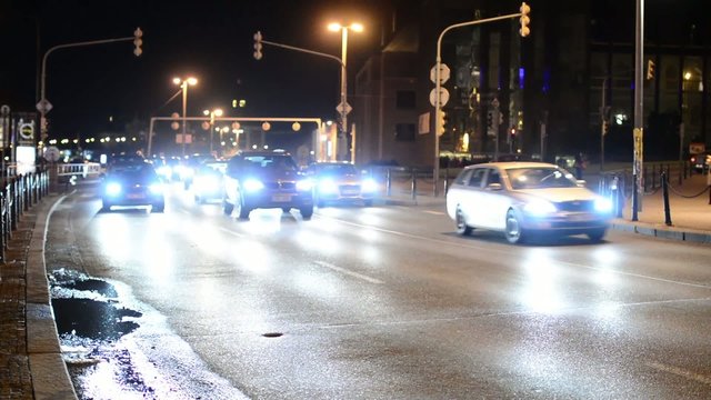 night city - night urban street with cars - car headlight