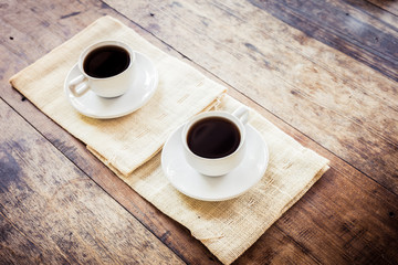 Two cups of coffee on brown napkin