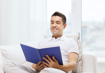 happy man reading book at home