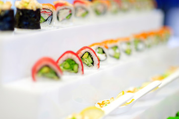 Fototapeta na wymiar Delicious sushi with avocado topping