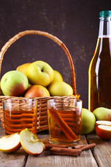 still life with apple cider and fresh apples on wooden table