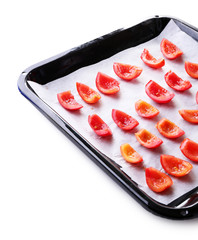 Tomatoes on drying tray, isolated on white