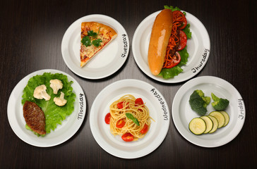 Fototapeta na wymiar Daily menu. Plates with food on table