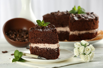 Delicious chocolate cake on table on light background