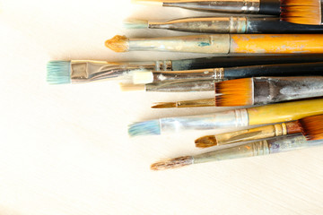 Obraz premium Different paintbrushes on fabric background