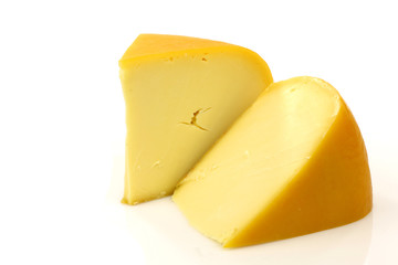 traditional Gouda cheese pieces on a white background - obrazy, fototapety, plakaty