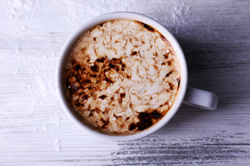 Cup of coffee on wooden background