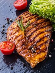 Steak chicken breast olive oil cherry tomatoes pepper and rosema