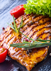 Steak chicken breast olive oil cherry tomatoes pepper and rosema