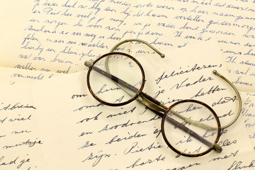 old pair of glasses on a letter