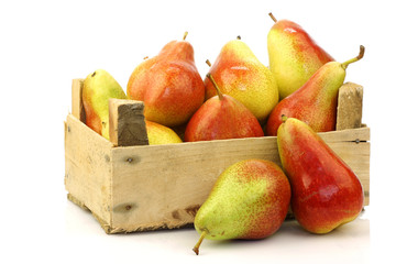  "Forelle" pears in a wooden crate on a white background