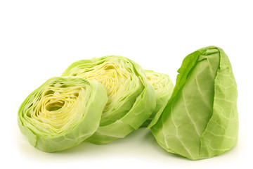 a fresh cut green pointed cabbage on a white background