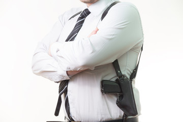 pistol in a holster under his arm a man on white background