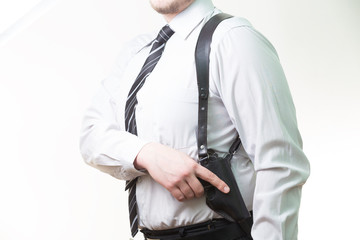 man holding a gun in a holster under his arm