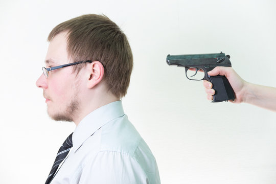 put gun to back of head man in shirt and tie