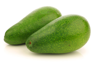 two fresh and ripe avocado's on a white background