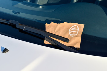 Message under a windshield wiper with easter egg and copy space