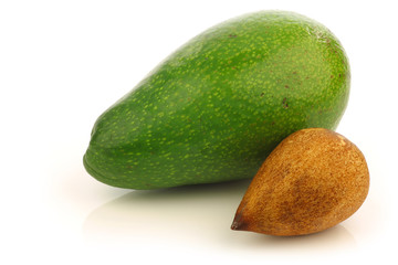 ripe avocado and a seed on a white background