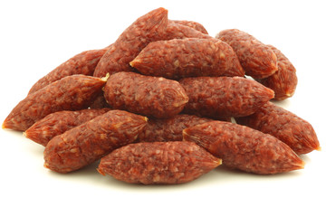 small cervelat sausages on a white background