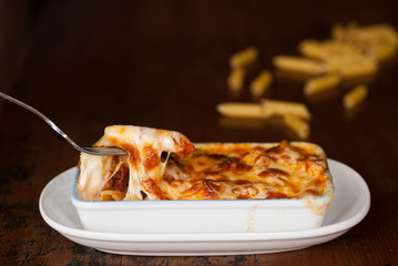 Baked penne pasta with tomato sauce and cheese