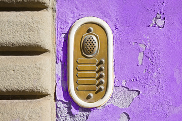 Old colored bell system on purple plaster (Tuscany - Italy)