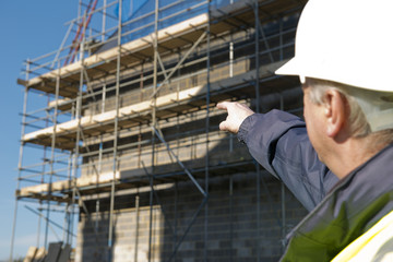 Naklejka na ściany i meble Civil Engineer Pointing Out To Building
