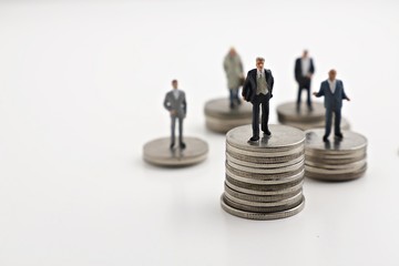  businessmans stand on the money coin white background