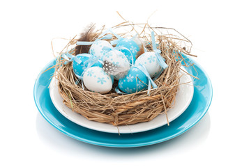 Naklejka na ściany i meble Easter eggs nest on plate