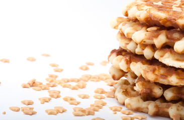 Stack of round waffles on white background with many stars