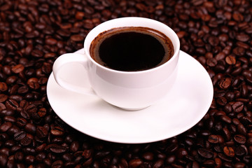 cup of black coffee, and coffee beans around