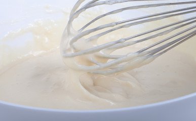 Mixed batter in a bowl and whisk