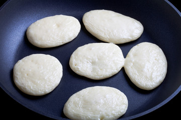 Fototapeta na wymiar Baking of pancake from batter in a pan