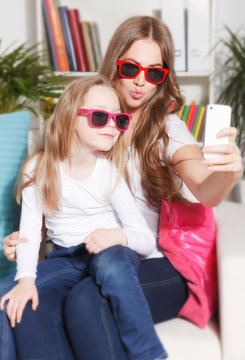 Happy woman and child taking a selfie