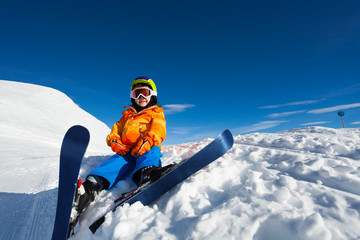 Fototapeta na wymiar Smiling boy wearing ski mask and helmet on snow